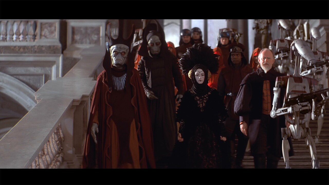 The invasion met little resistance, and Gunray traveled to Naboo’s capital, Theed, to compel Amid...