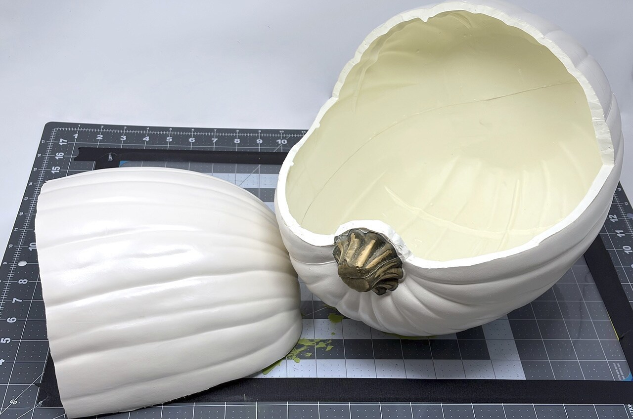 Step 2: Use a craft knife to cut off the top 2/3 of the horizontal pumpkin, cutting around the stem. Remove the section you cut.