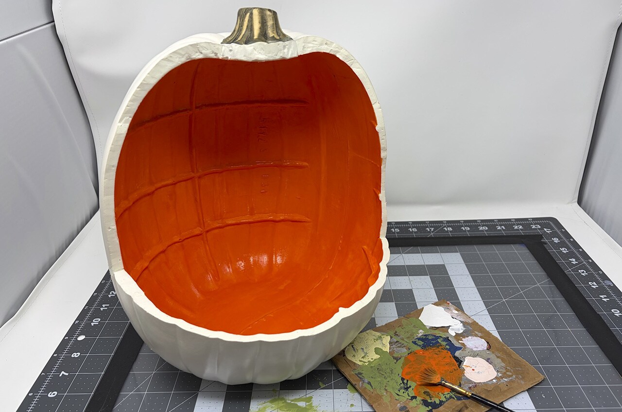 Step 4: Use tape to mask off two stripes on either side of the pumpkin, close to the opening at the top.