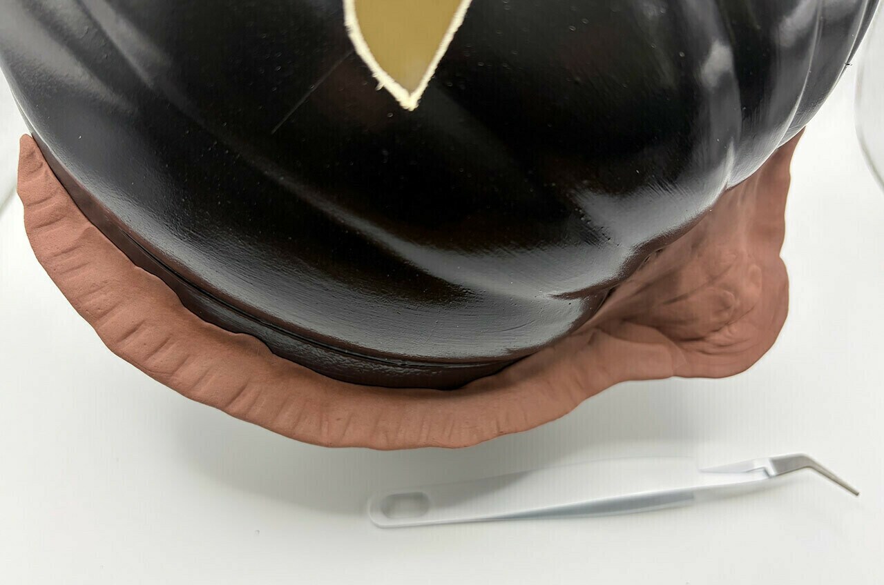 Use the modeling clay to add a large frill around the pumpkin stem and down the sides of a pumpkin.