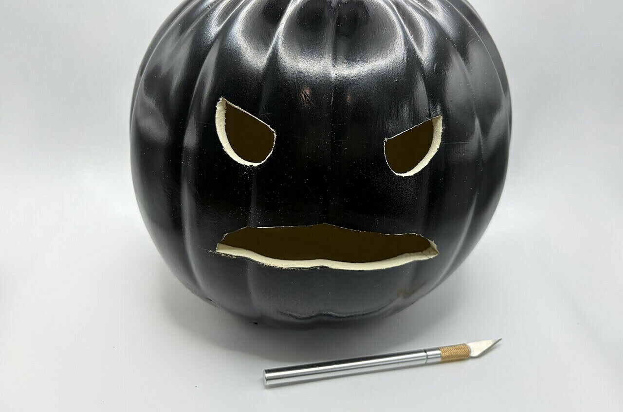 Carefully cut the eyes and mouth out with a craft knife.