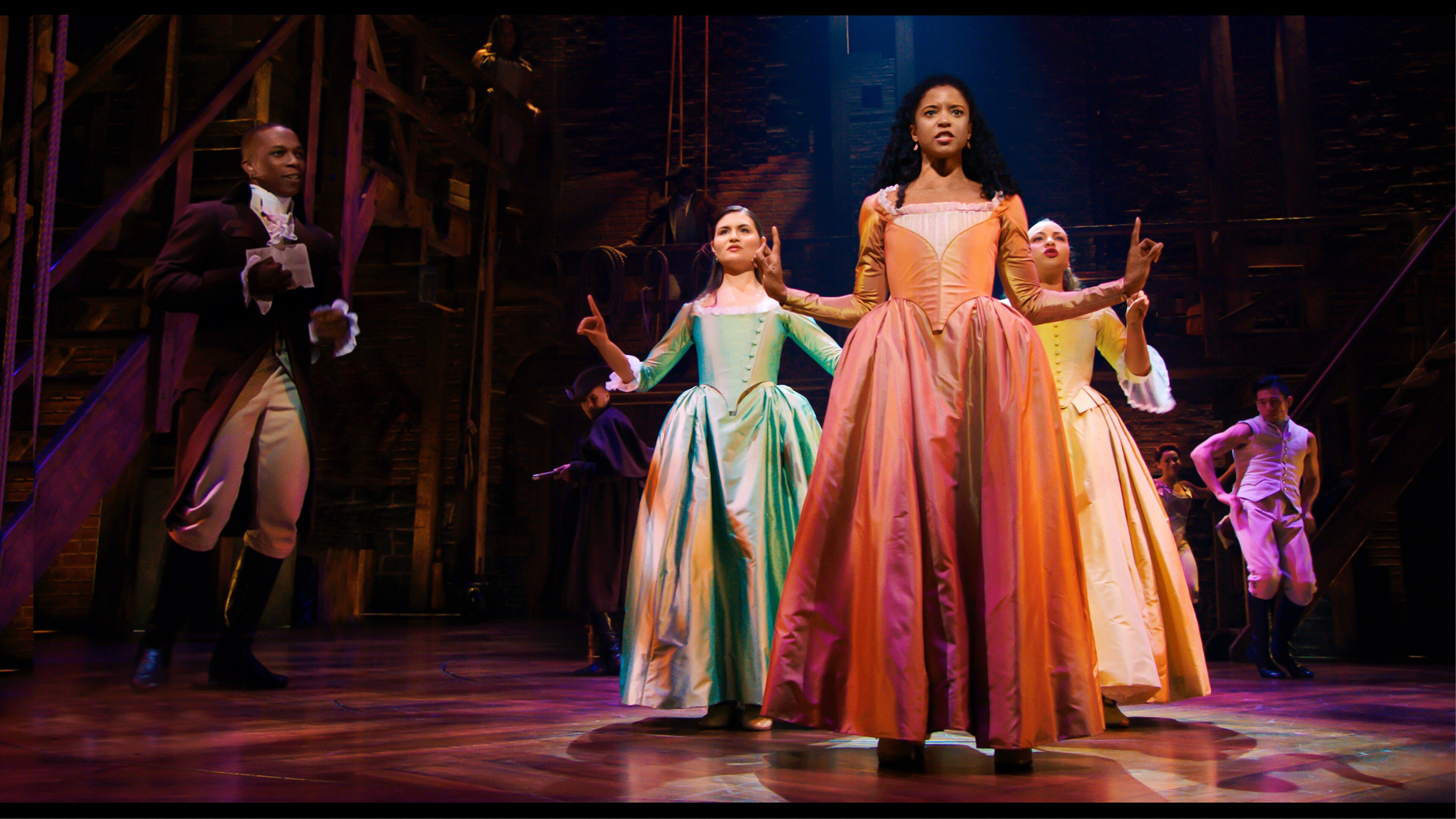 Phillipa Soo is Eliza Hamilton, Renée Elise Goldsberry is Angelica Schuyler and Jasmine Cephas Jones is Peggy Schuyler in HAMILTON, the filmed version of the original Broadway production.