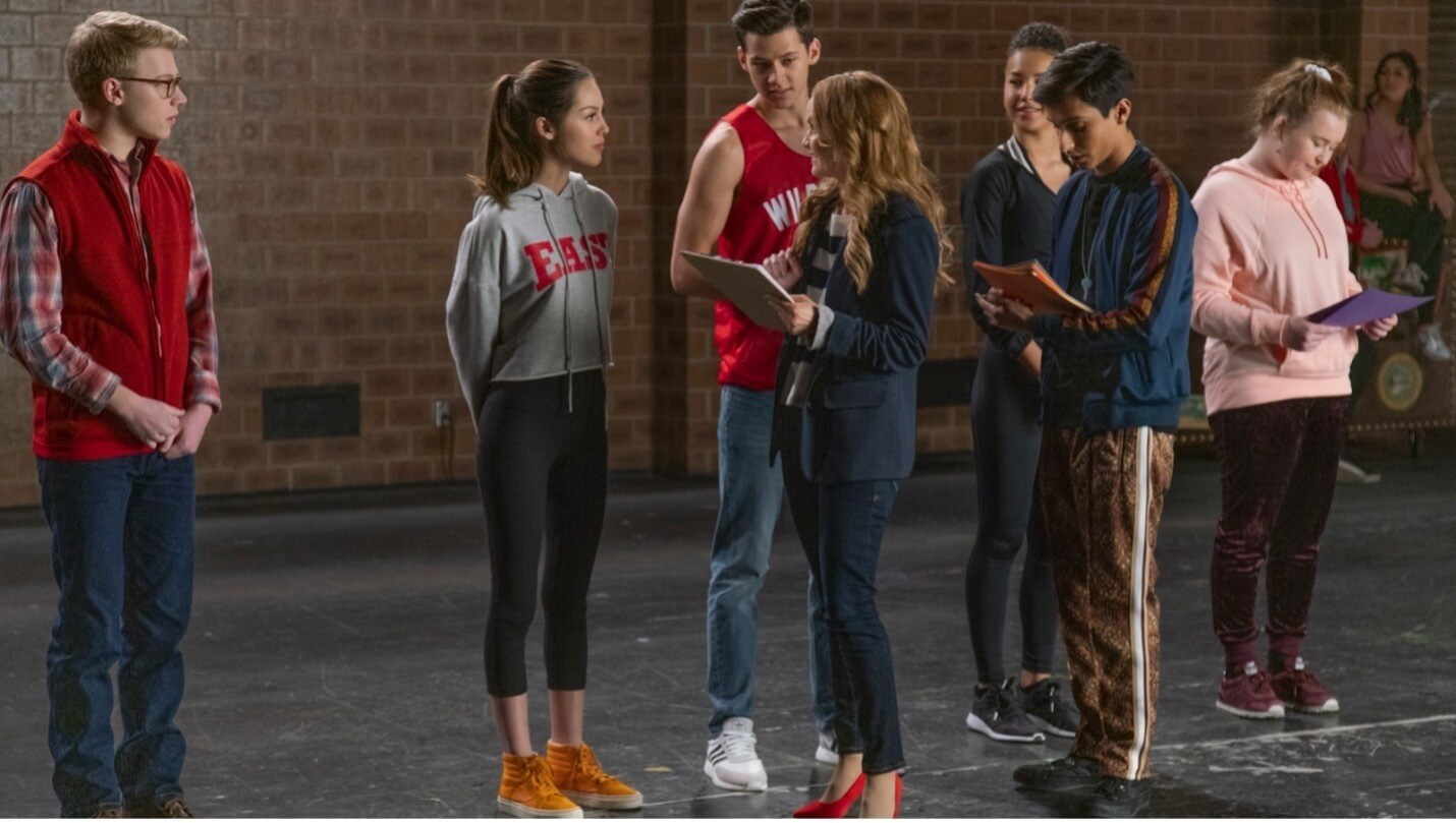 Students stand around in High School Musical: The Musical: The Series