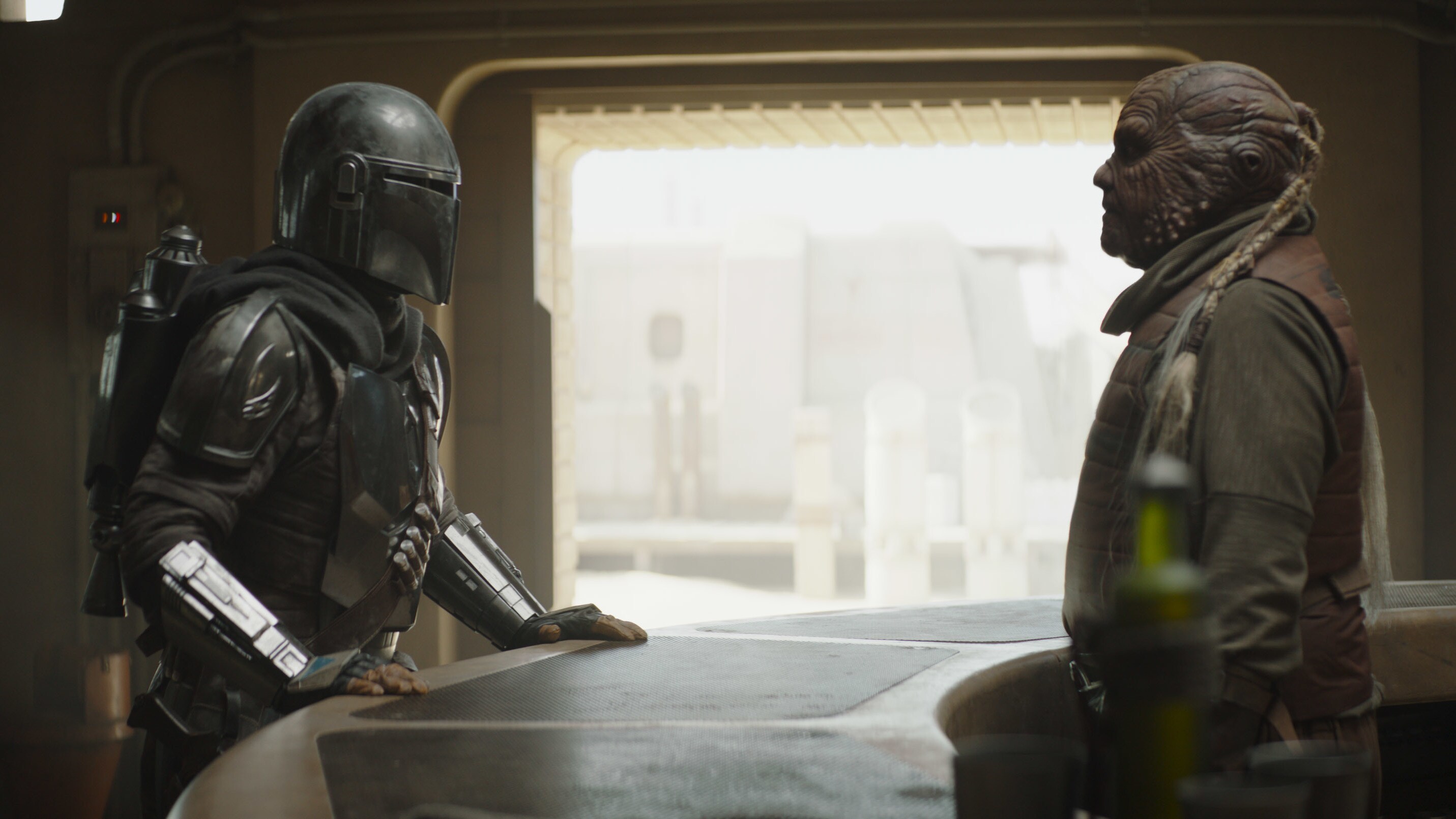 The Mandalorian (Pedro Pascal) and Weequay bartender in Lucasfilm's THE MANDALORIAN, season two, exclusively on Disney+. © 2020 Lucasfilm Ltd. & ™. All Rights Reserved.