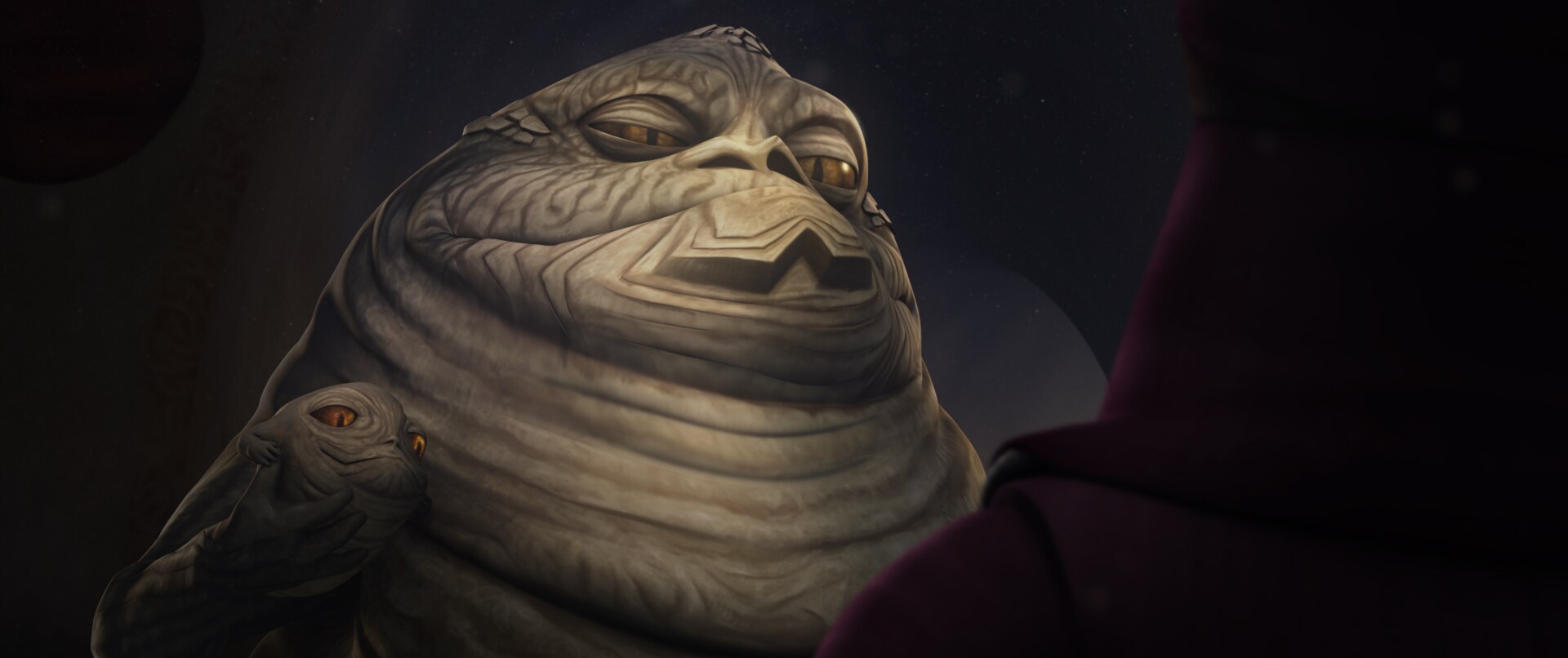 Jabba the Hutt holding Rotta the Huttlet in The Clone Wars feature.