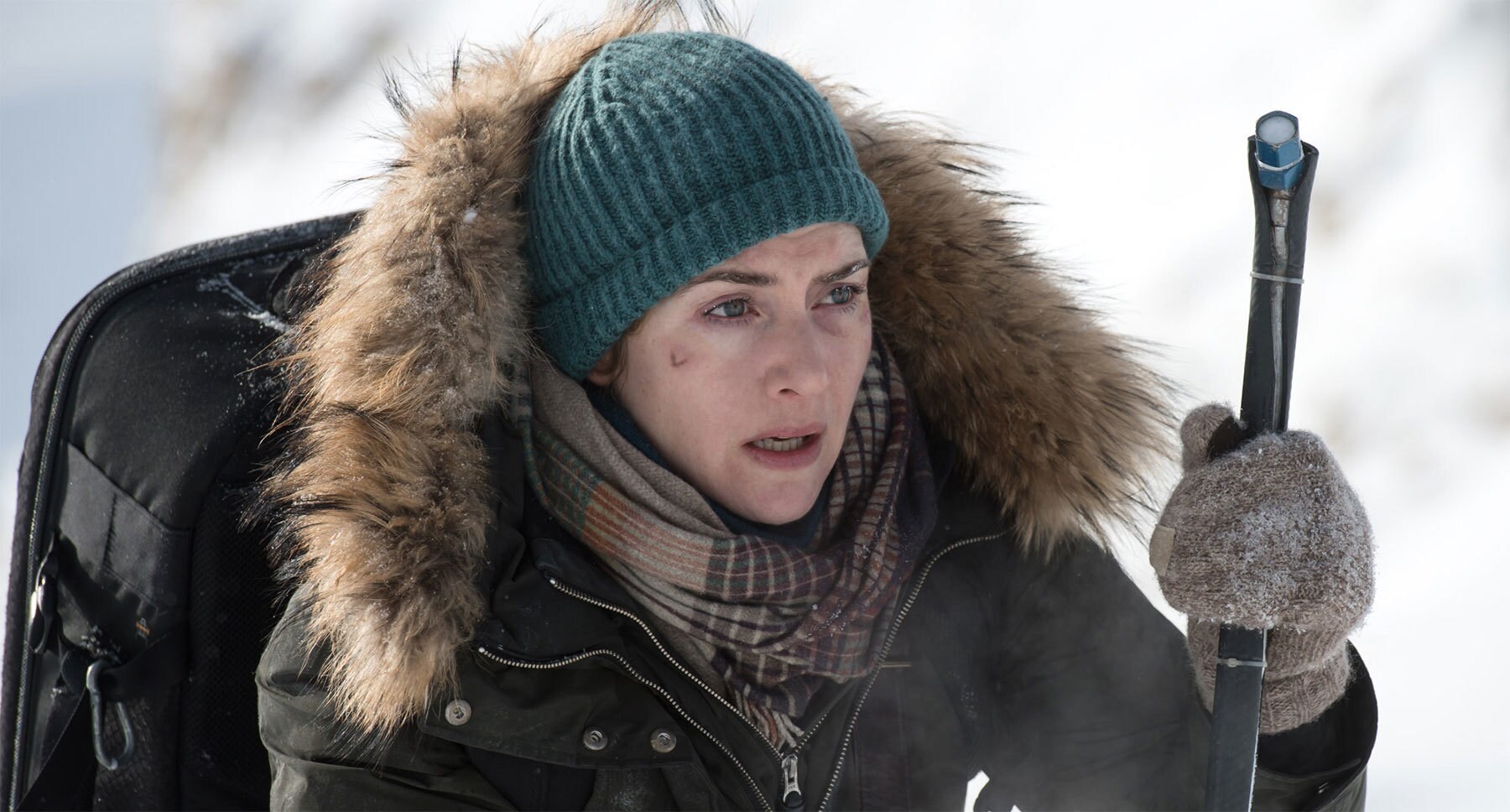 Kate Winslet (as Alex Martin) on a snowy mountain in the movie "The Mountain Between Us"