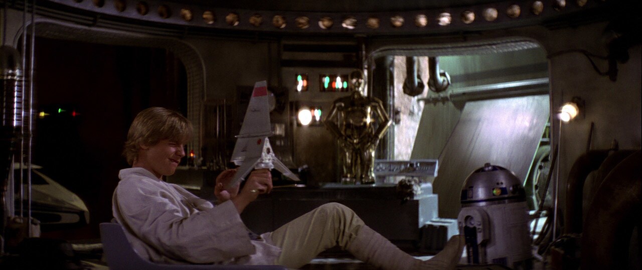 Luke Skywalker plays with a model T-16 Skyhopper.
