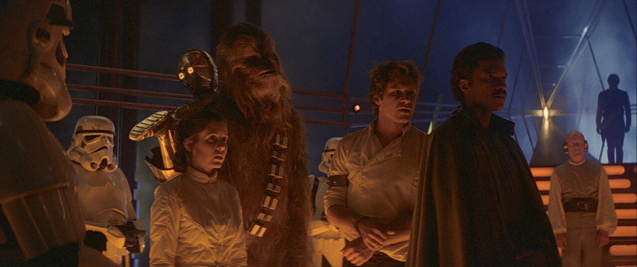Leia, Chewie, Han, Lando, C-3PO, and stormtroopers in The Empire Strikes Back.