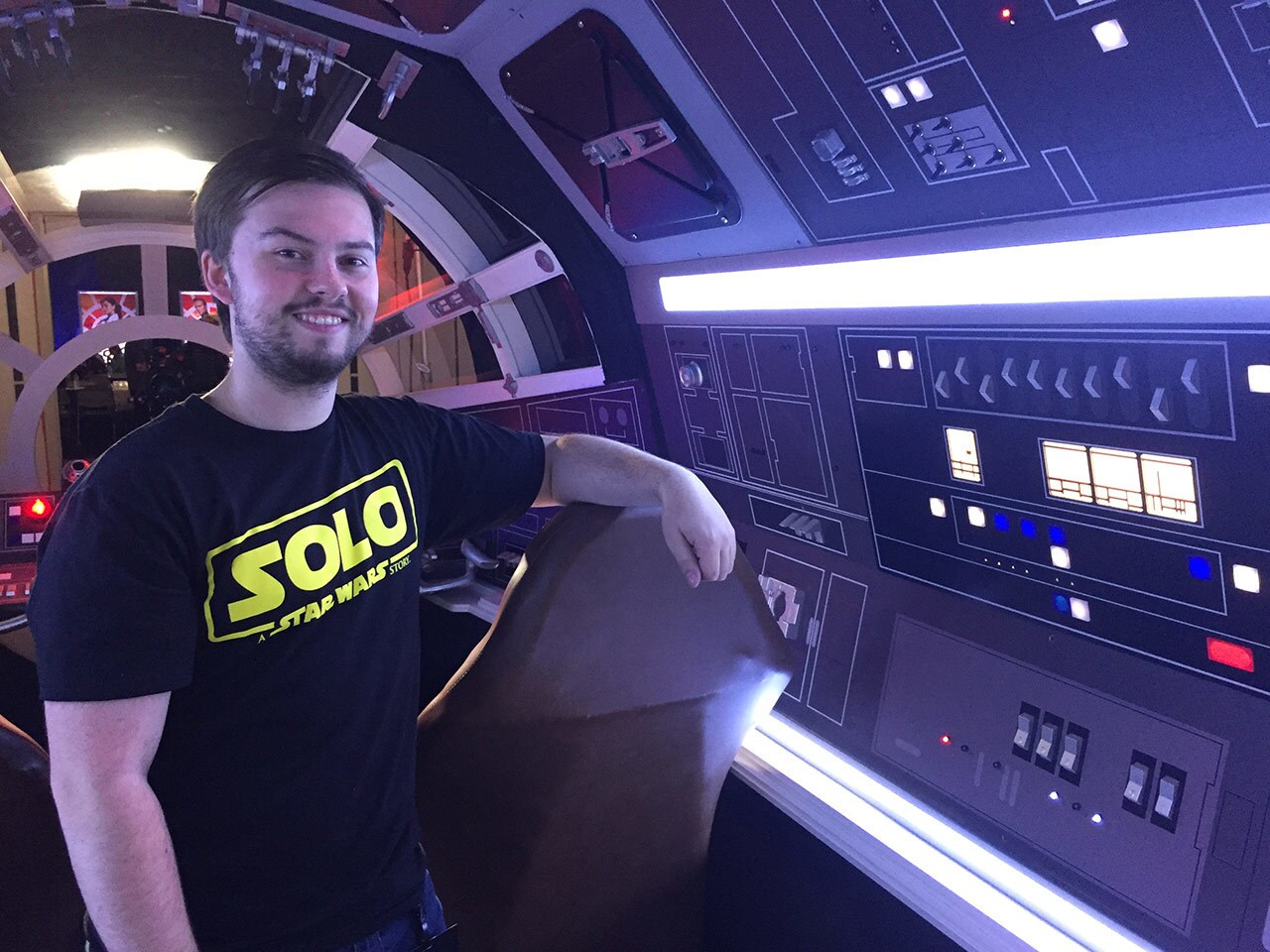 Builder Kevin Cembolista poses next to a control panel on the Millennium Falcon Experience.