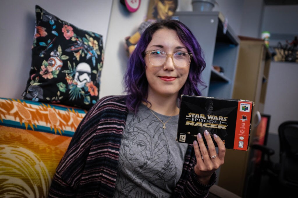 A member of the Lucasfilm Games Team holds up the box of Star Wars Episode I: Racer.
