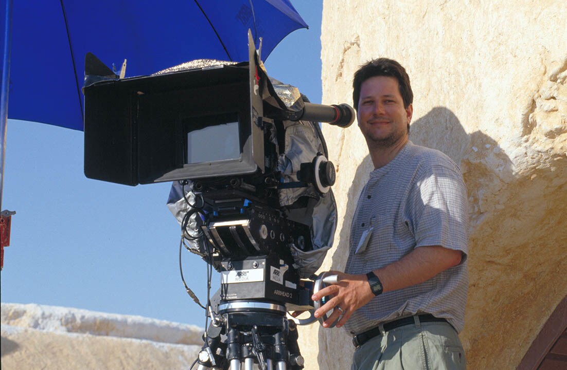 "Main Unit on the Mos Espa set. John Knoll (Visual Effects Supervisor) by the camera, on location near Tozeur, Tatooine."