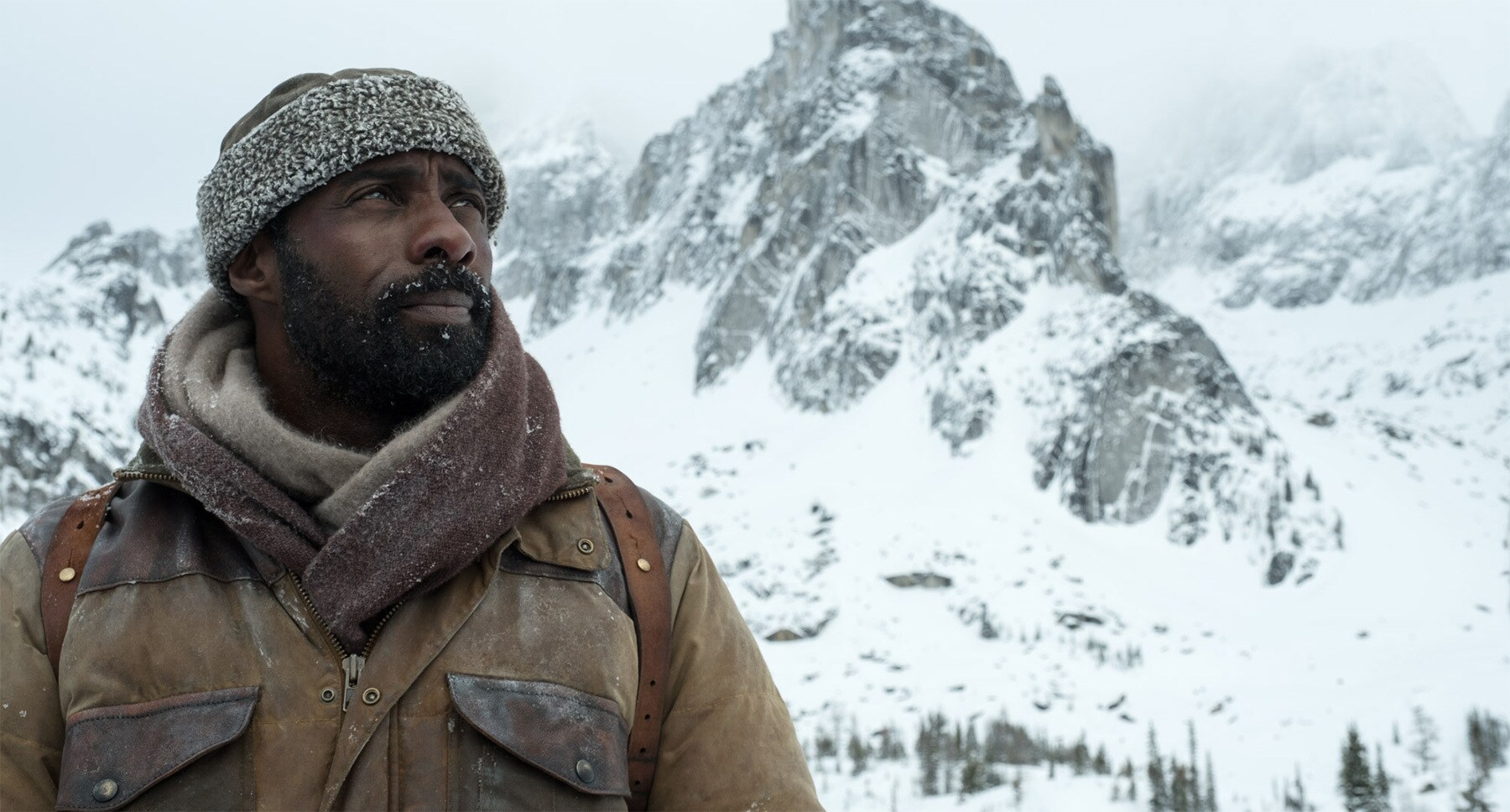 Idris Elba (as Ben Bass) on a snowy mountain in the movie "The Mountain Between Us"