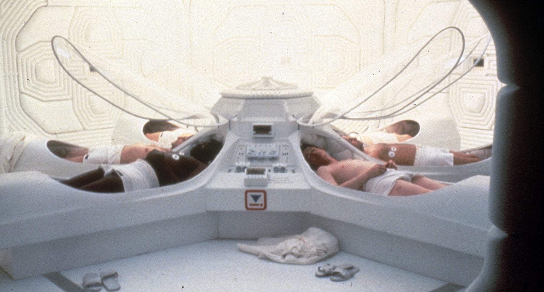 Characters laying inside white pods in the film "Alien."