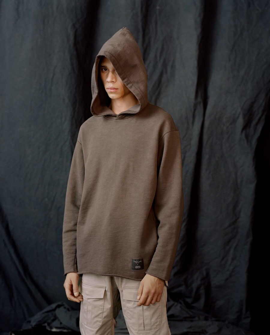 A model poses while wearing a hoodie from Marcus Wainwright's Rag & Bone collection for a modern Jedi.