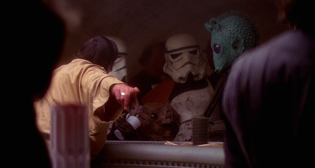 The cantina bartender points out where Luke and Obi-Wan were sitting for two Stormtroopers.