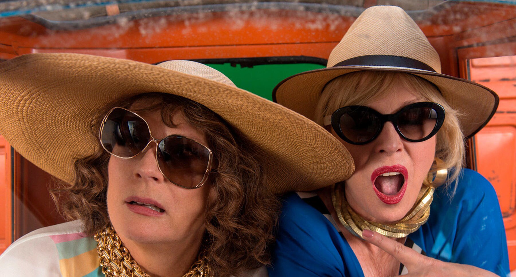 Actors Jennifer Saunders (as Edina) and Joanna Lumley (as Patsy) wearing Straw hats and sunglasses in "Absolutely Fabulous: The Movie"