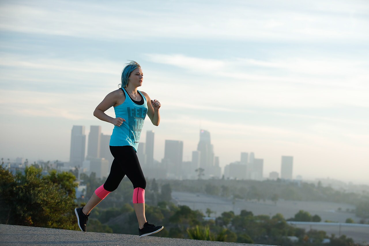 A runner jogs in front of a city skyline as part of Fuel Your Force.