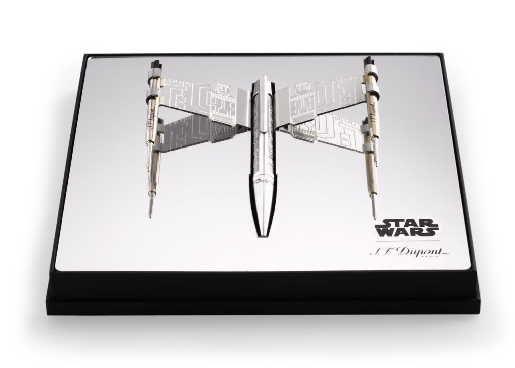 A luxury pen and cradle designed to look like an X-Wing, in a display box.