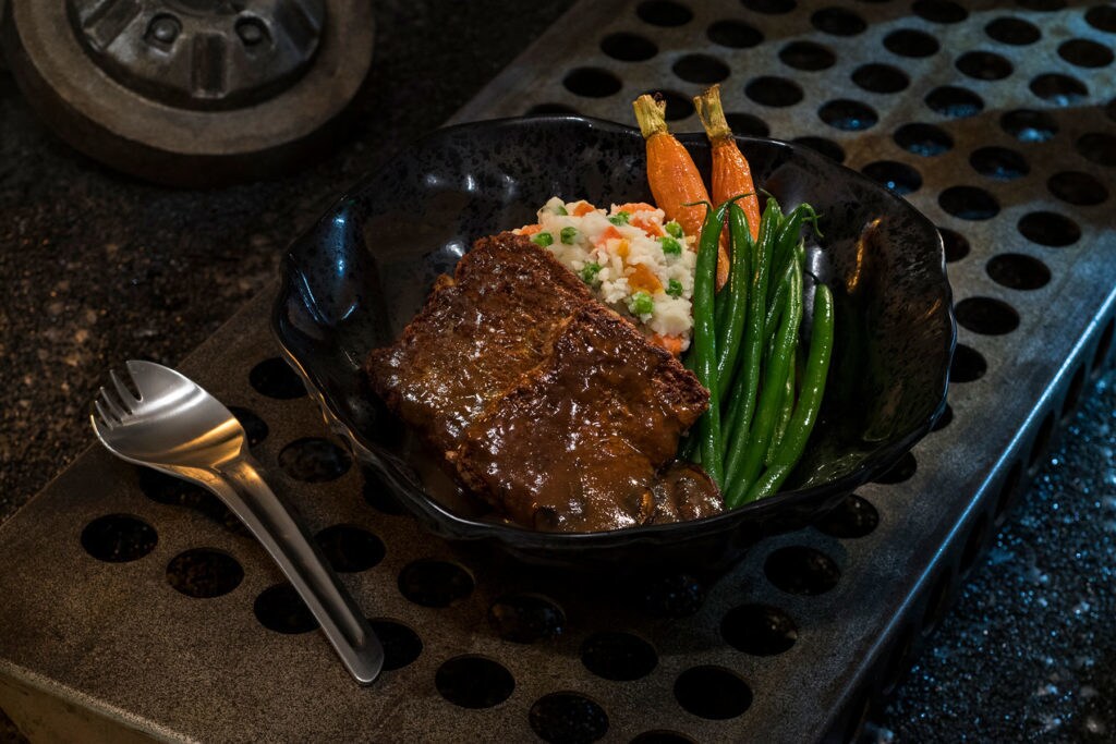 The Ithorian Garden Loaf, found at Docking Bay 7 Food and Cargo inside Star Wars: Galaxy’s Edge, is a plant-based “meatloaf” dish served with roasted vegetable mash, seasonal vegetables and mushroom sauce. (David Roark/Disney Parks)