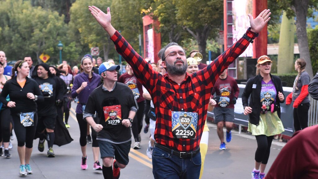 Runner Kirk McDuck, cosplaying as George Lucas, jogs in a runDisney Star Wars race.