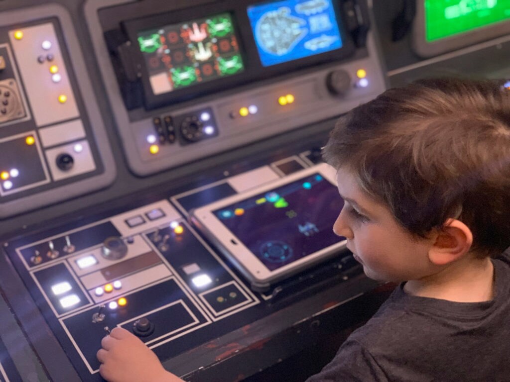 A young fan in the Star Wars Command Center on the Disney Fantasy from Disney Cruise Line.