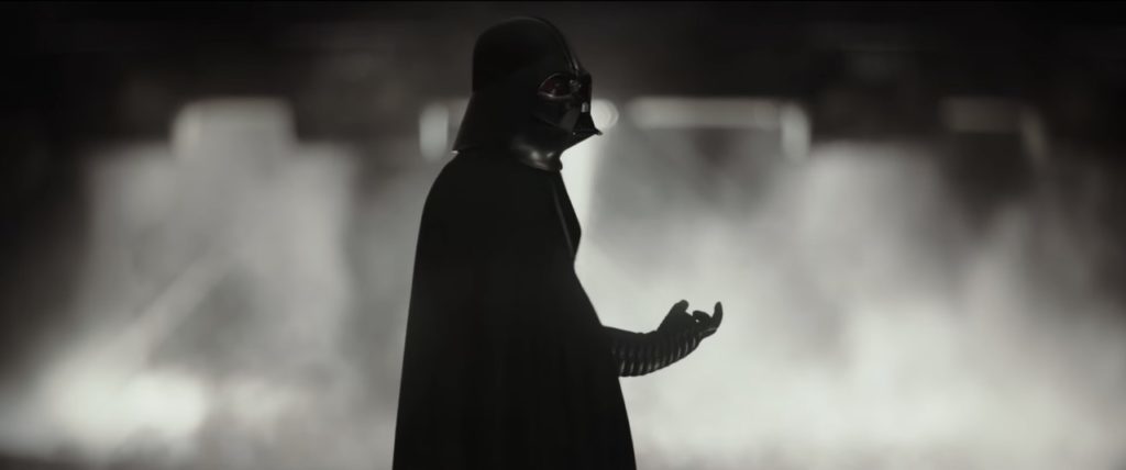 Darth Vader holds his fingers in a choking gesture, in a scene from Rogue One.