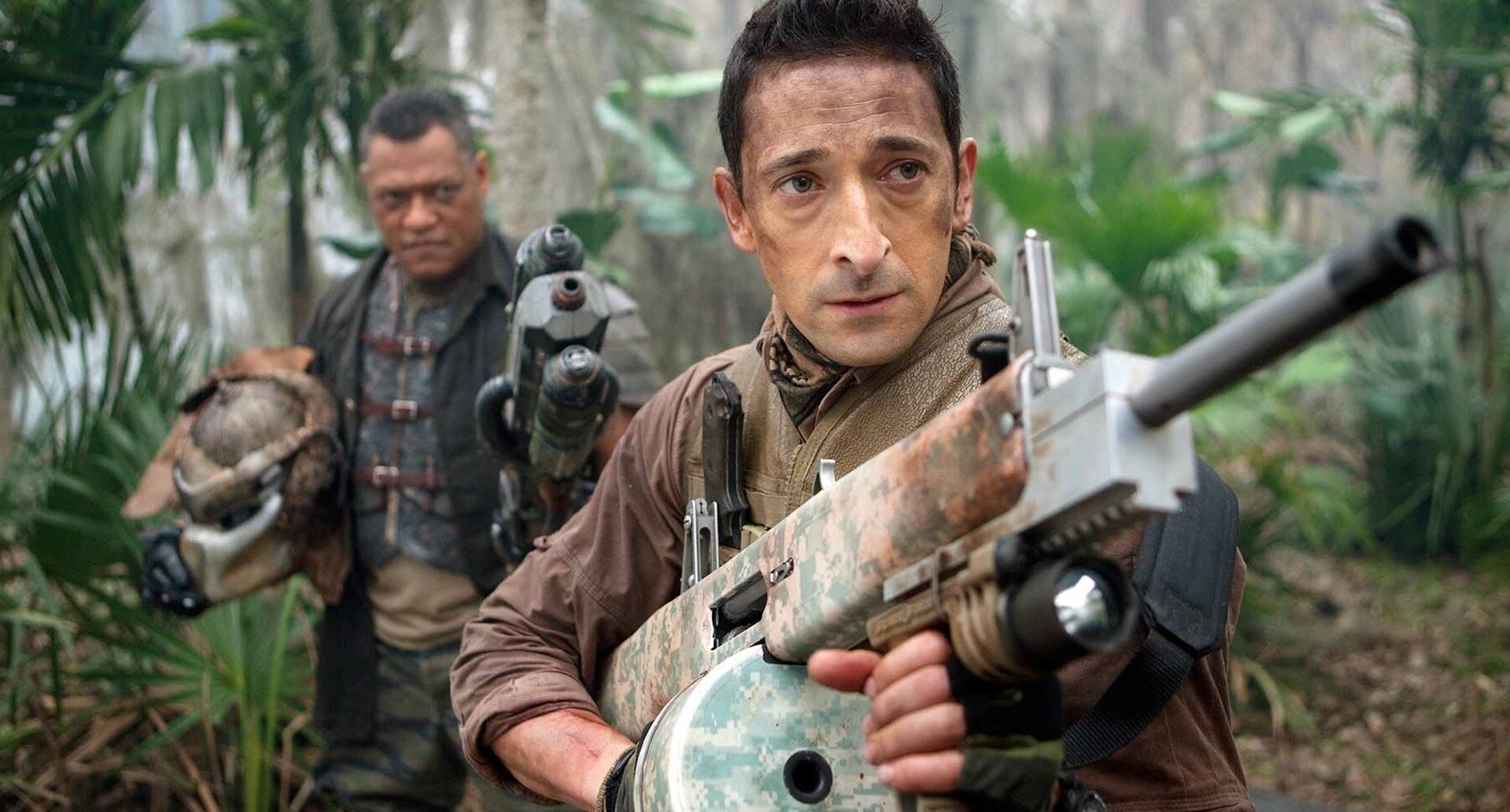 Adrien Brody (as Royce) and Laurence Fishburne (as Ronald Noland) holding a Predator's head in the movie "Predators"