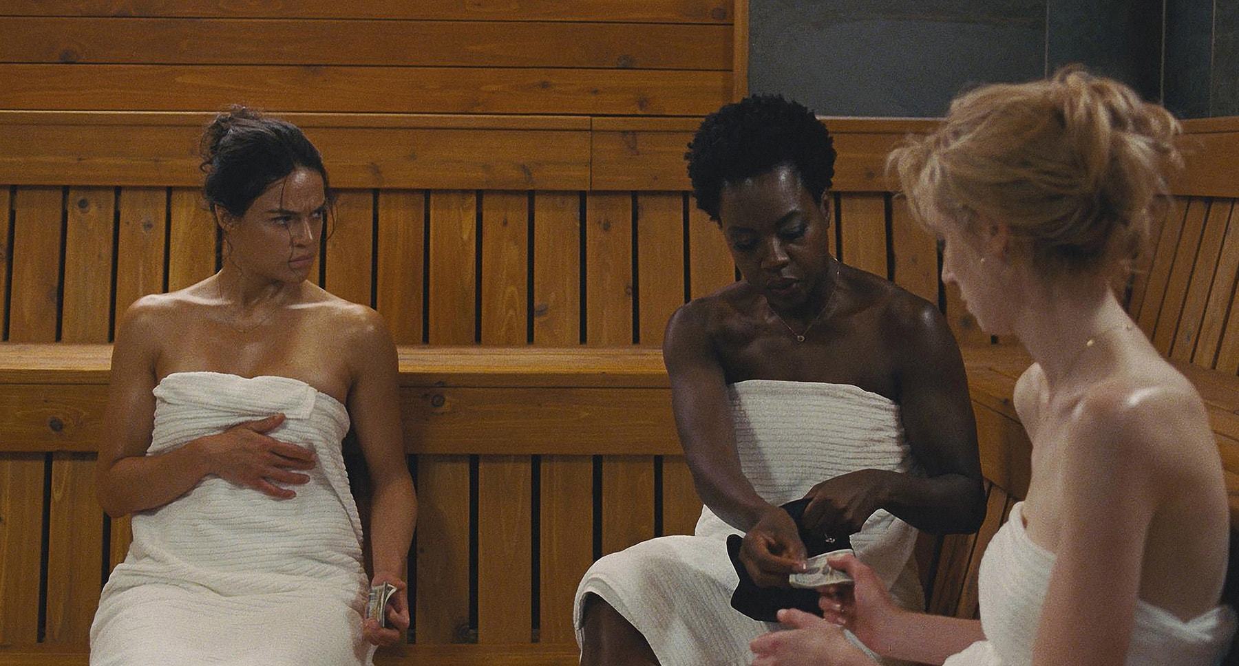 Viola Davis, Michelle Rodriguez, and Elizabeth Debicki sitting in a sauna in "Widows"