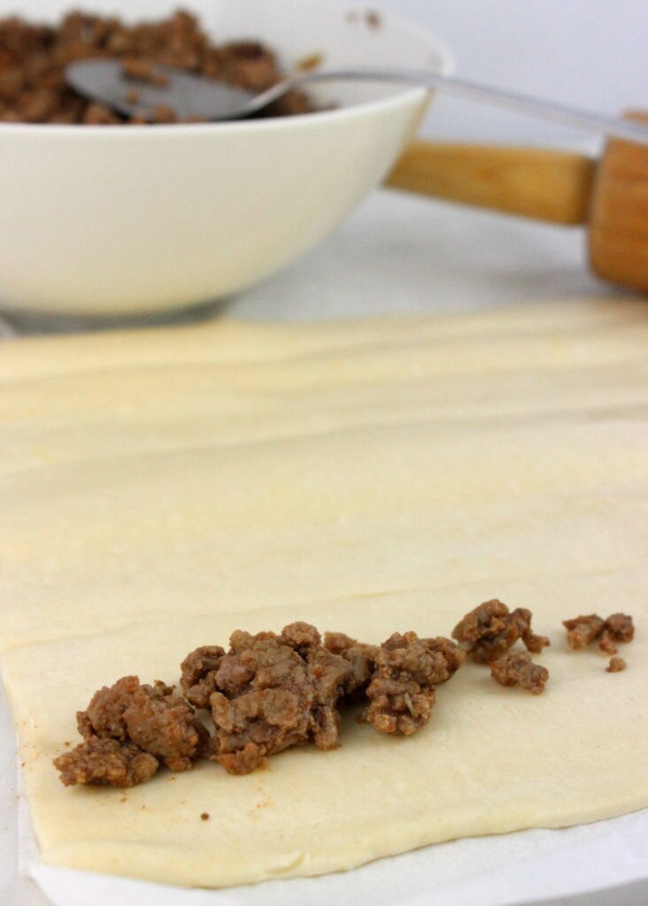 A ground beef mixture on rolled-out dough.