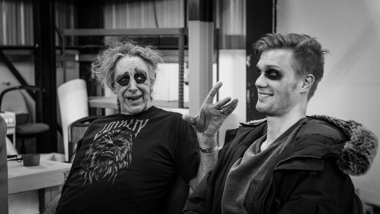 Peter Mayhew and Joonas Suotamo sit together in a behind-the-scenes photo from The Force Awakens.