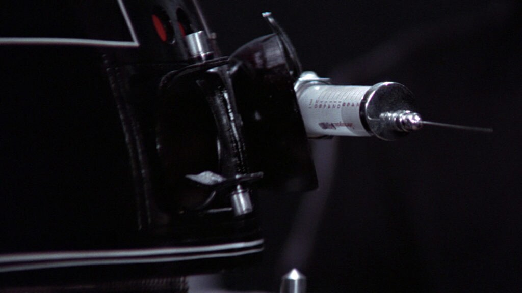 An Imperial interrogation droid carries a large needle.