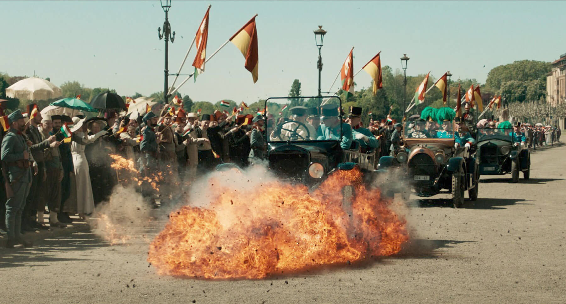 A car driving through fire in a scene from the movie "The King's Man"