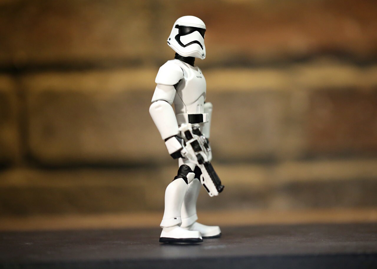 A stormtrooper figurine with blaster.