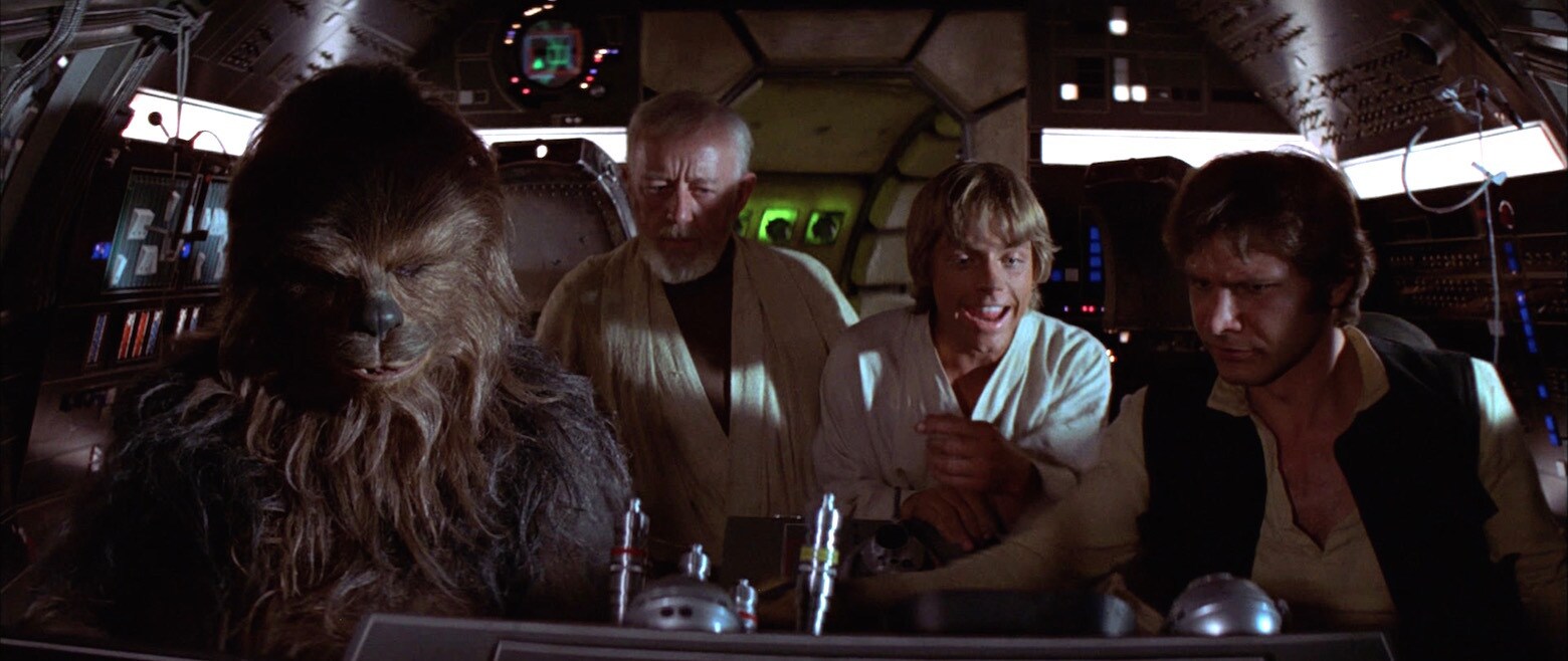 Han and Chewie pilot the Millennium Falcon while Obi-Wan and Luke observe in A New Hope.