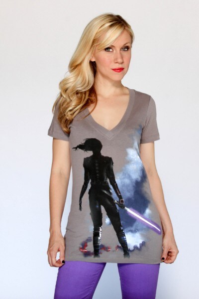 Voice actor and Her Universe founder Ashley Eckstein poses in a t-shirt depicting a lightsaber-wielding Jaina Solo.