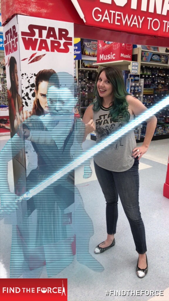 A holographic Rey holds a lightsaber from Find the Force, an augmented reality scavenger hunt game with game player Amy Ratcliffe.