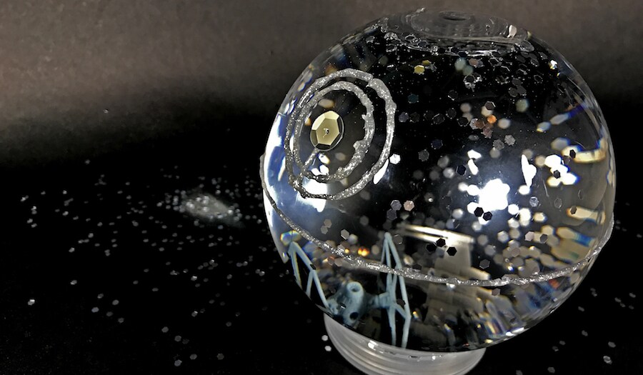 A homemade arts-and-crafts Death Star glitter globe.