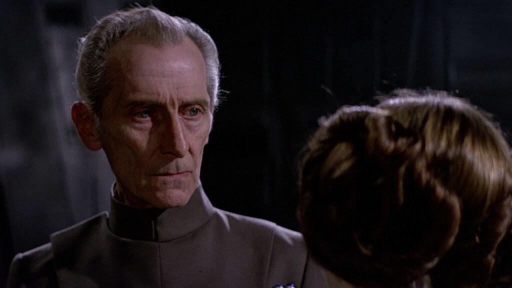 Grand Moff Tarkin stares at Princess Leia.