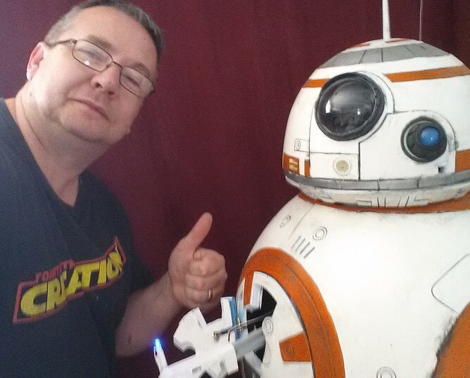 Fan Jamie Young gives a thumbs-up, along with his homemade model of BB-8.