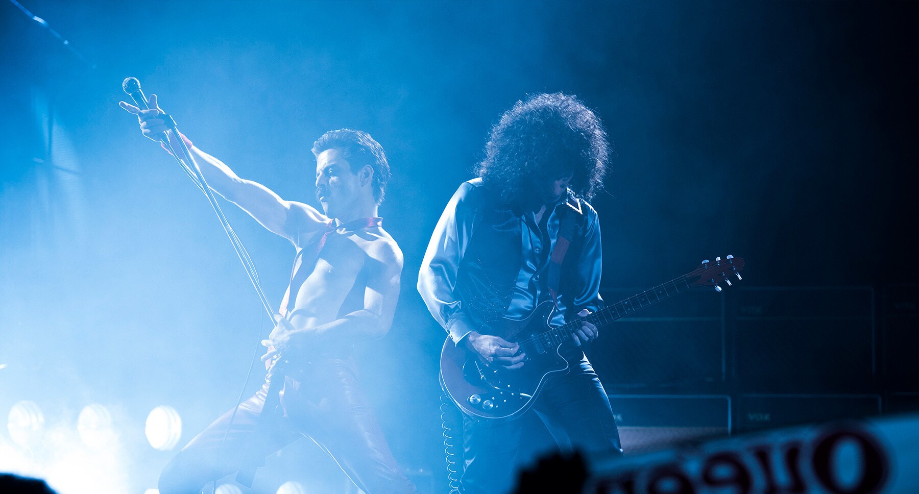 Actors Rami Malek (as Freddie Mercury) and Gwilym Lee (as Brian May) performing on stage in the movie "Bohemian Rhapsody"