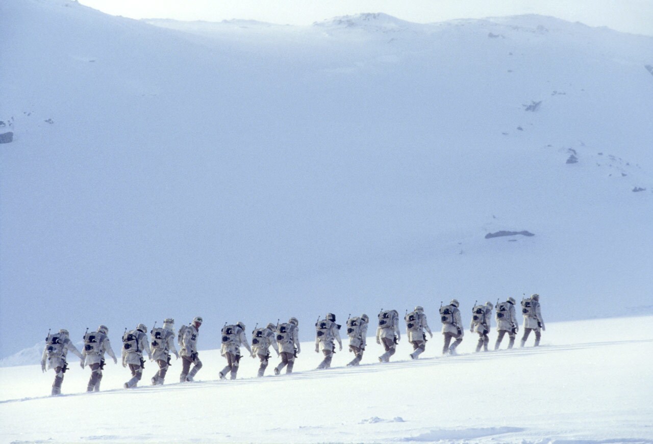 Rebel fighters hike through the snow on the icy planet of Hoth.
