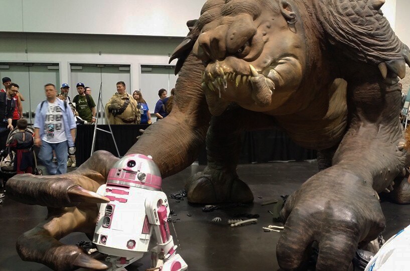 An exhibit of R2-KT fleeing from a rancor.