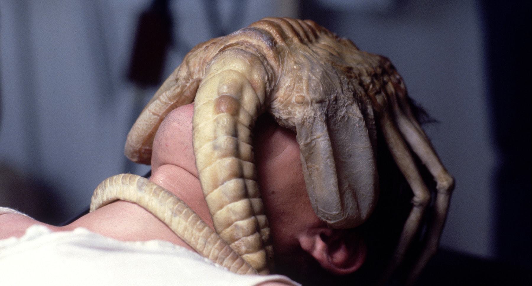 Face Hugger Alien attached to a character's face in the film "Alien" 