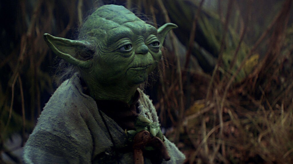 Yoda stands amid the swampy landscape of Dagobah in The Empire Strikes Back.