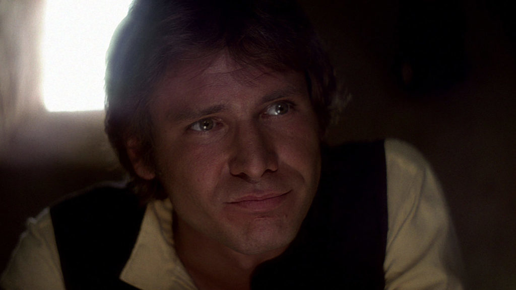 Han Solo sits in the Mos Eisley Cantina in A New Hope.