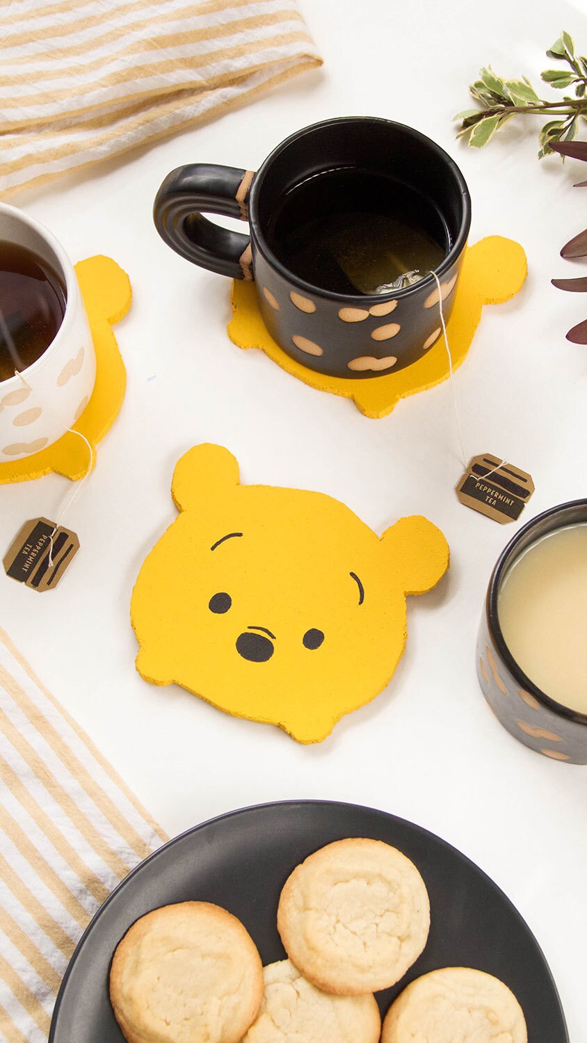 A yellow Winnie the Pooh drink coaster.