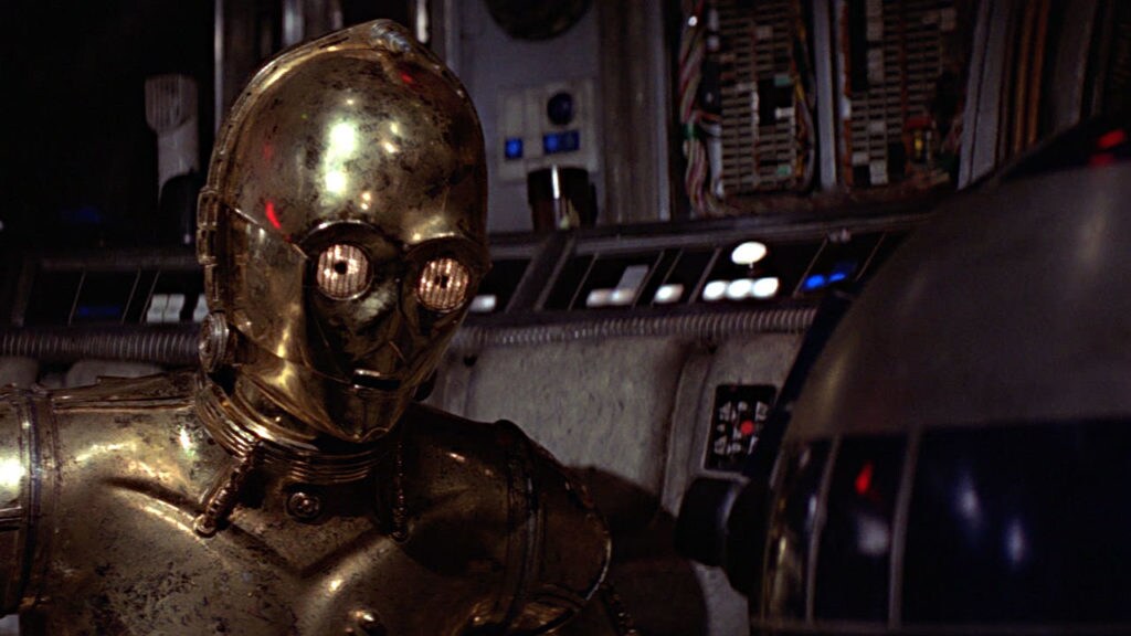 C-3PO looks down at R2-D2 in A New Hope.