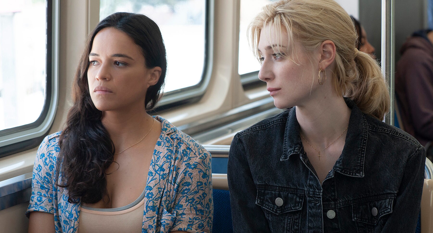 Michelle Rodriguez and Elizabeth Debicki sitting in a bus from the movie "Widows"