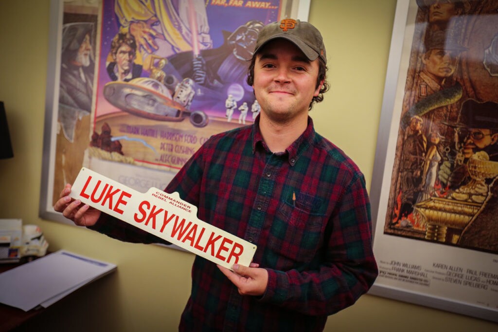 Lucasfilm's Lucas Seastrom with Luke Skywalker sign.