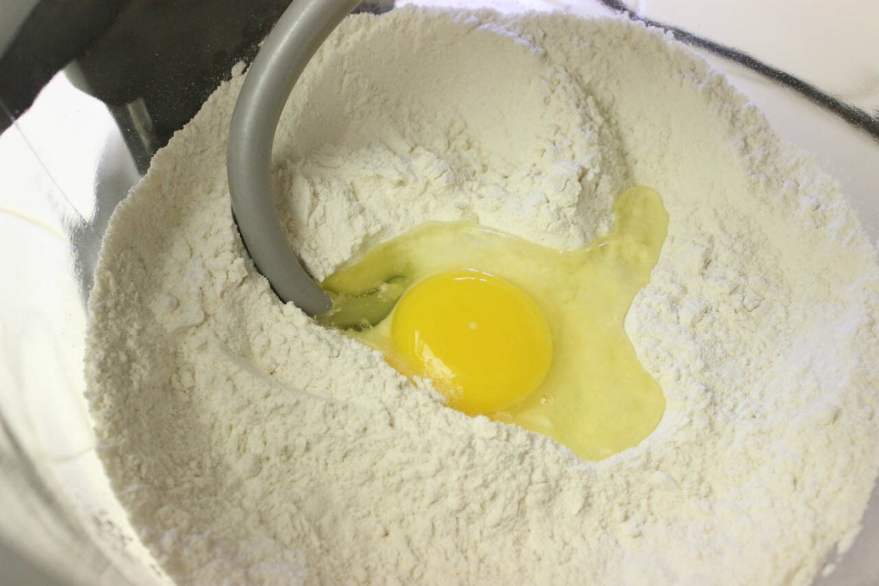An egg and flour in a bowl in preparation for making Snowtrooper Sliders.